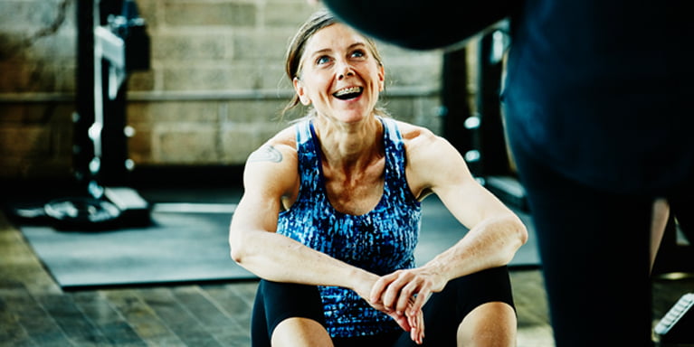 Image of a woman smiling while excercising