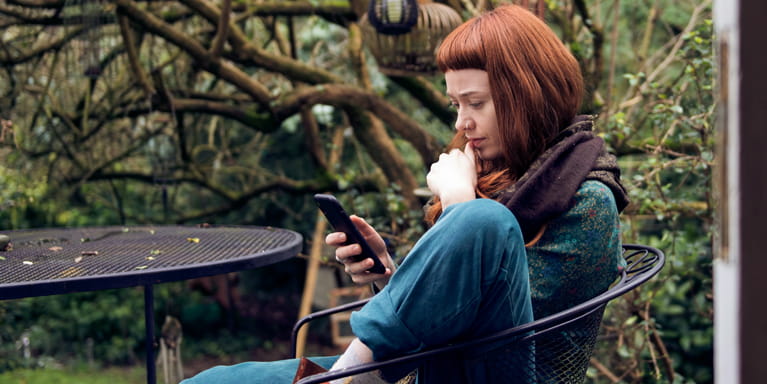 Woman in a garden on her mobile