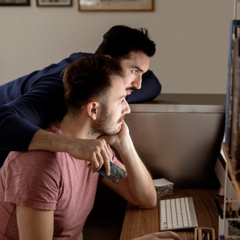 two people looking at a screen