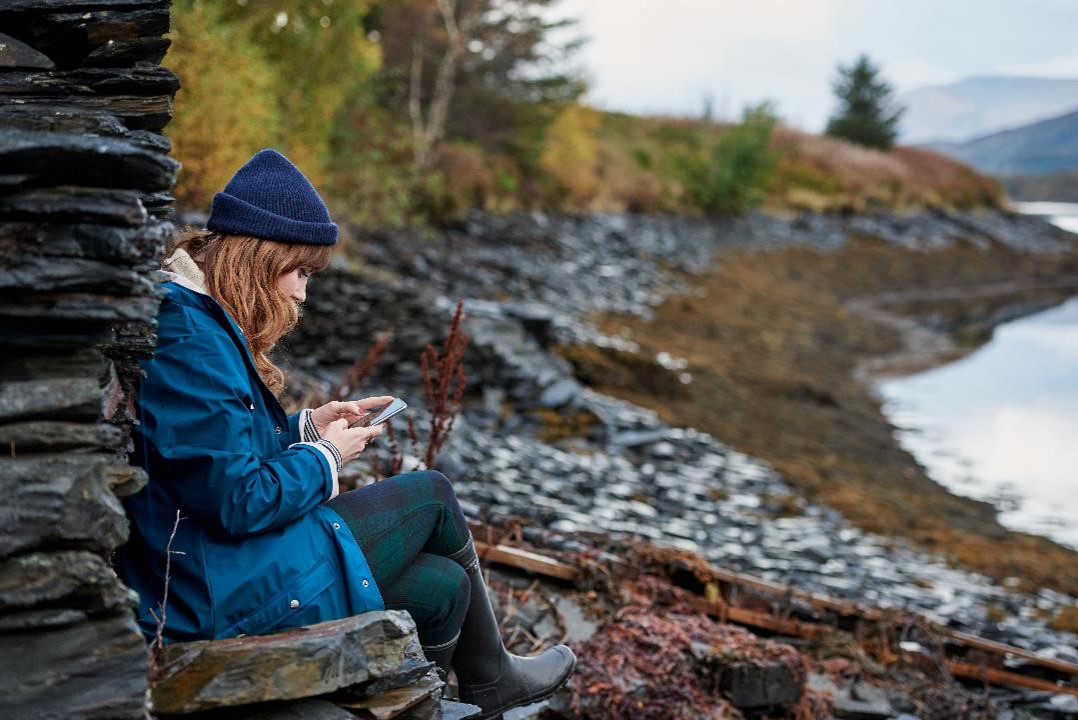 Woman sitting on rocks image