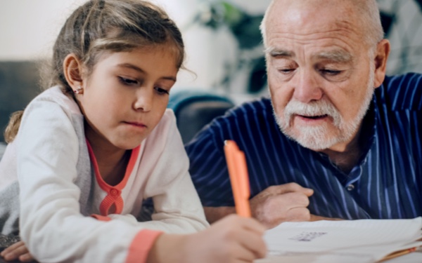 Grandparent helping child with homework
