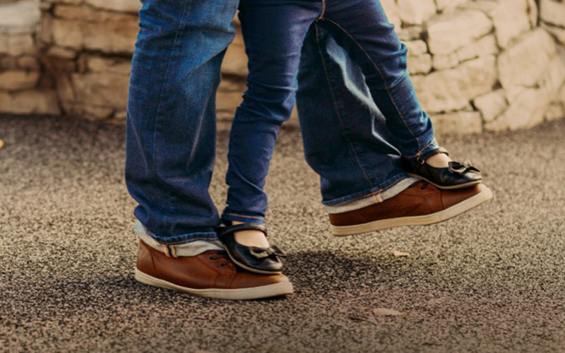 Child walking on parent's feet