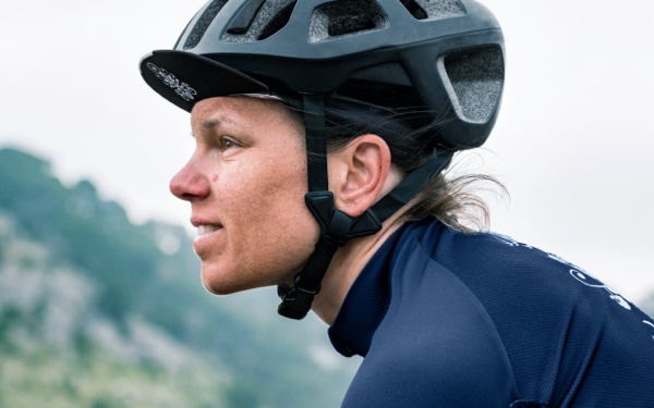 Person with cycling helmet on facing left