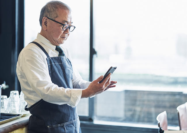 Man looking at mobile phone.