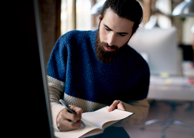 Man writing in notebook.